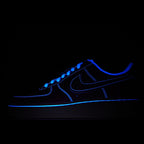 Blue Air Force 1 sneaker with glowing blue swoosh and stitching, lace-up side view.