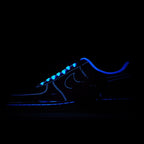 Dark Nike Air Force 1 sneakers with blue glowing laces and swoosh