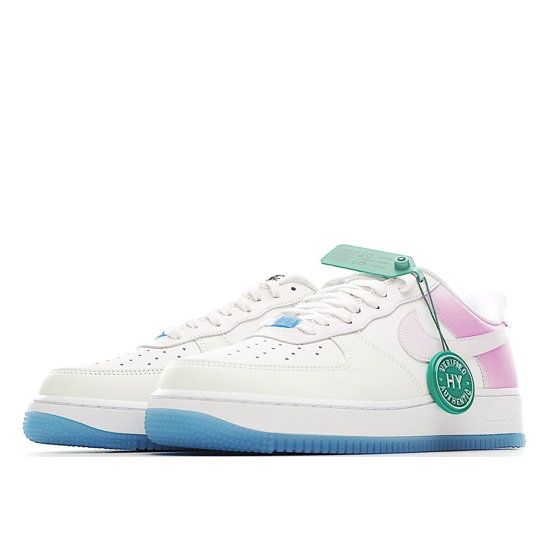 Low-top sneakers in white with pink heel panel and light-blue outsole; lace-up style