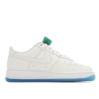 White low-top sneakers with light-blue outsole; side Swoosh logo and lace-up closure