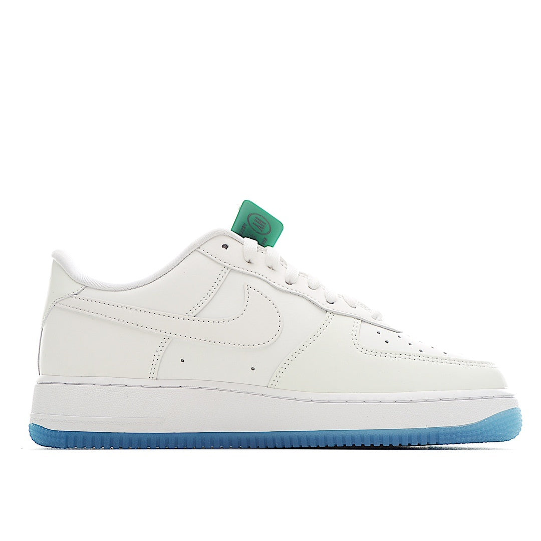 White low-top sneakers with light-blue outsole; side Swoosh logo and lace-up closure