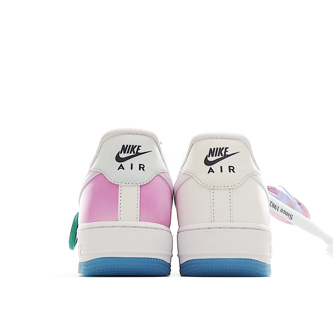 Pair of low-top sneakers with pink and white heel panels; blue outsole and lace-up design