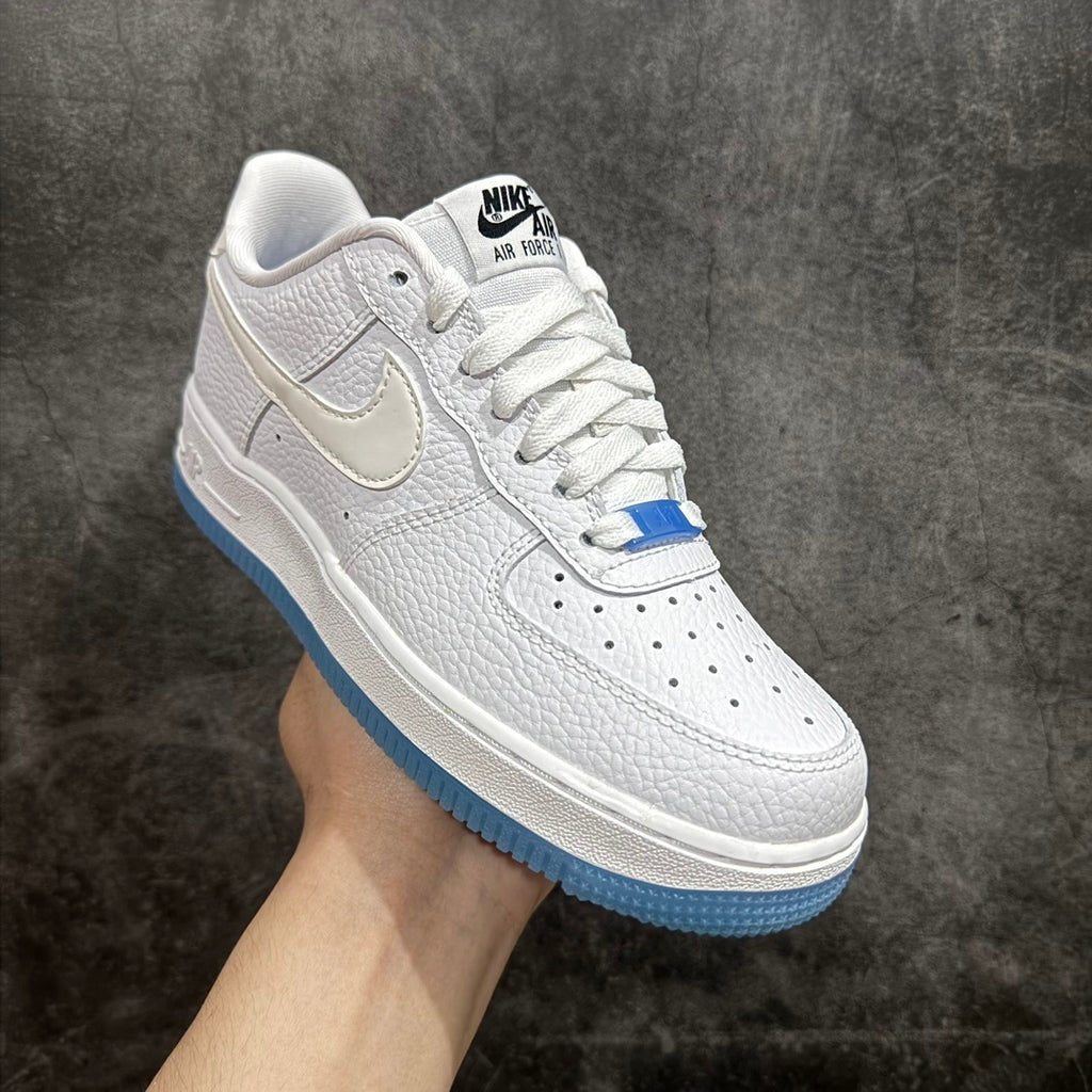Nike Air Force 1 sneaker three-quarter view, white upper with blue lace accent