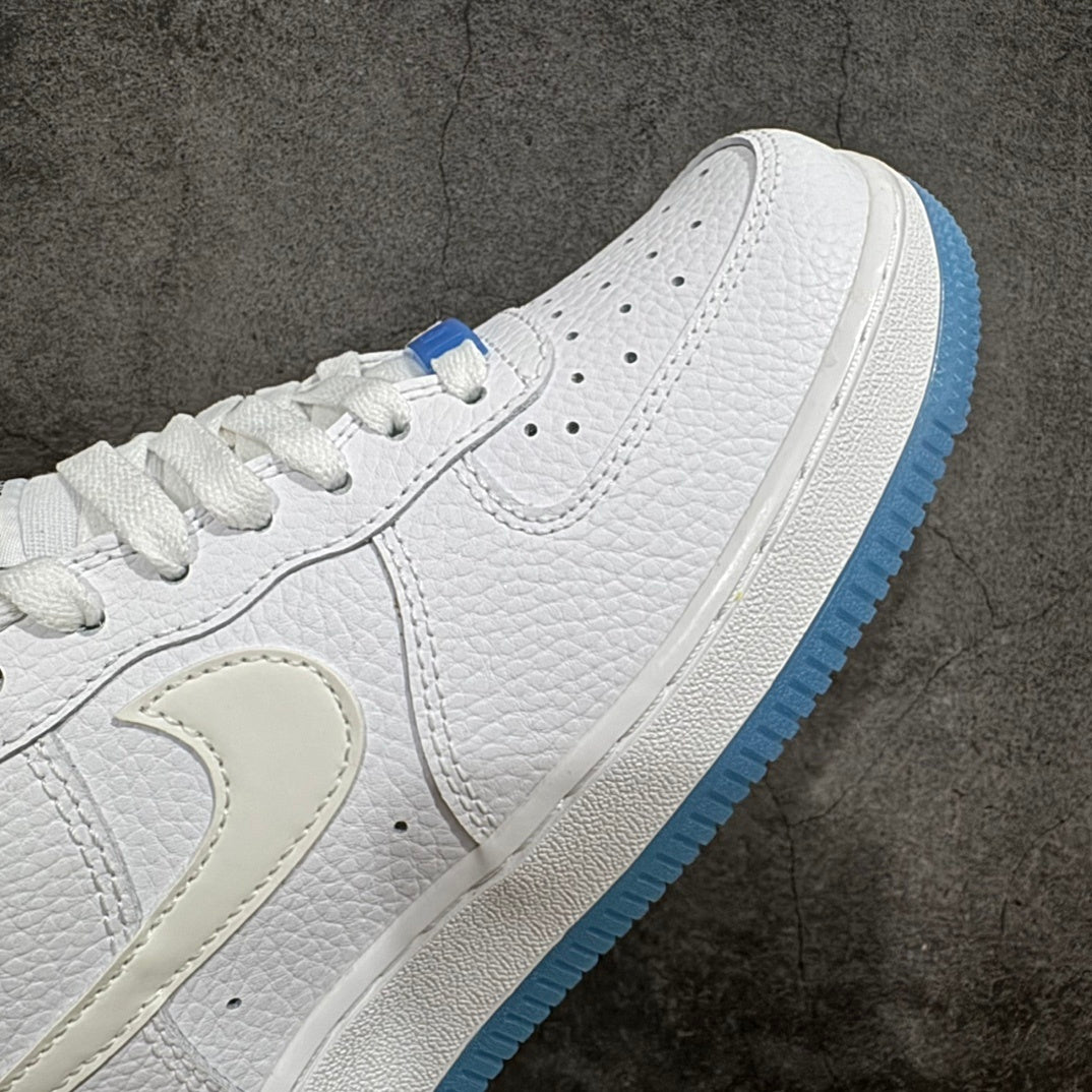 Nike Air Force 1 sneaker midfoot close-up with swoosh and blue outsole edge