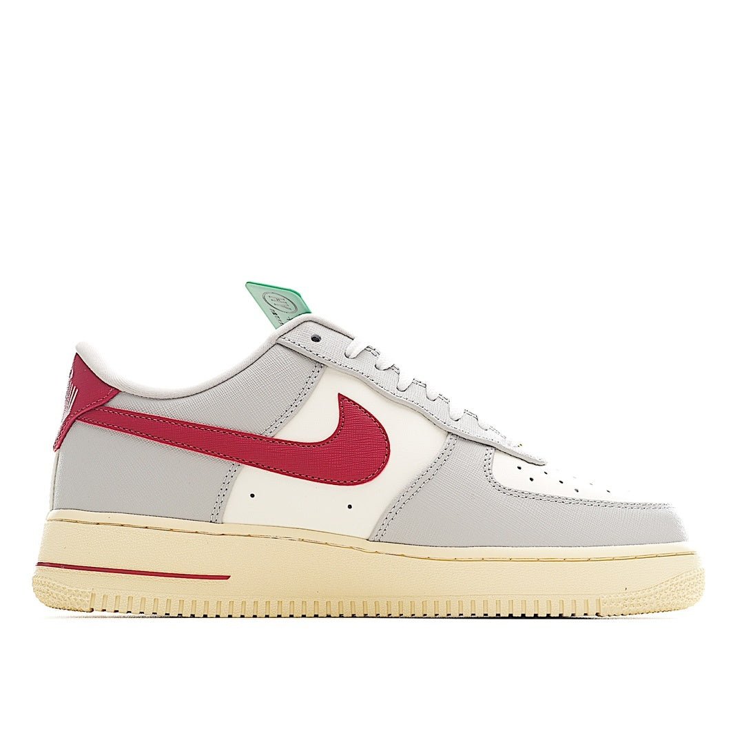 White Air Force 1-style sneakers with red swoosh and perforated toe detail