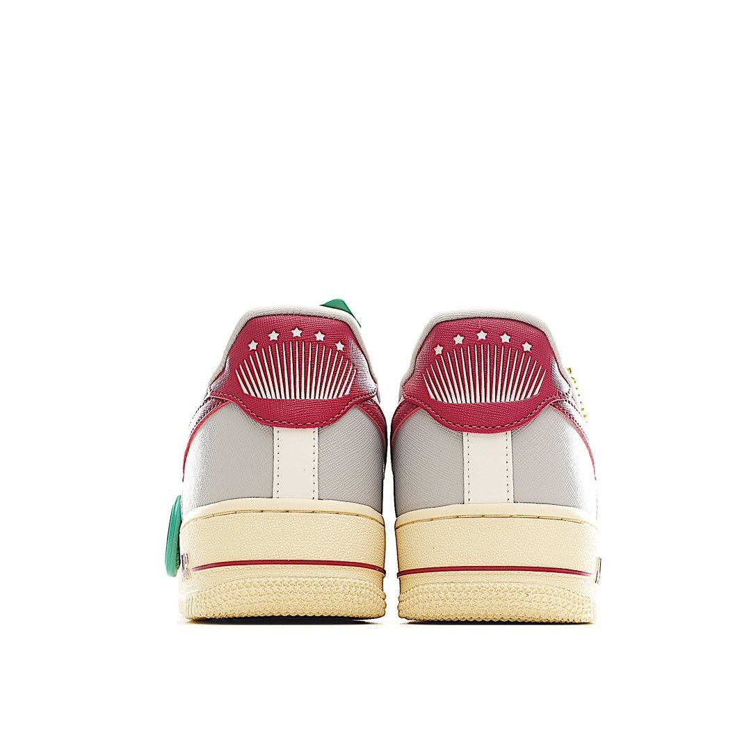 White Air Force 1-style sneakers with red heel accents and green hang tag