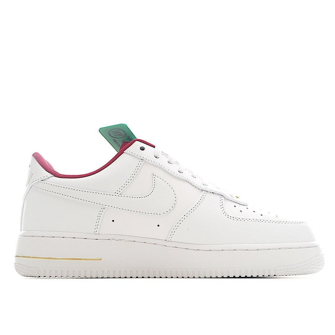 Nike Air Force 1 sneaker in white with pink collar and small gold accent
