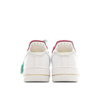 Nike Air Force 1 sneakers in white with rear pink trim and green tag