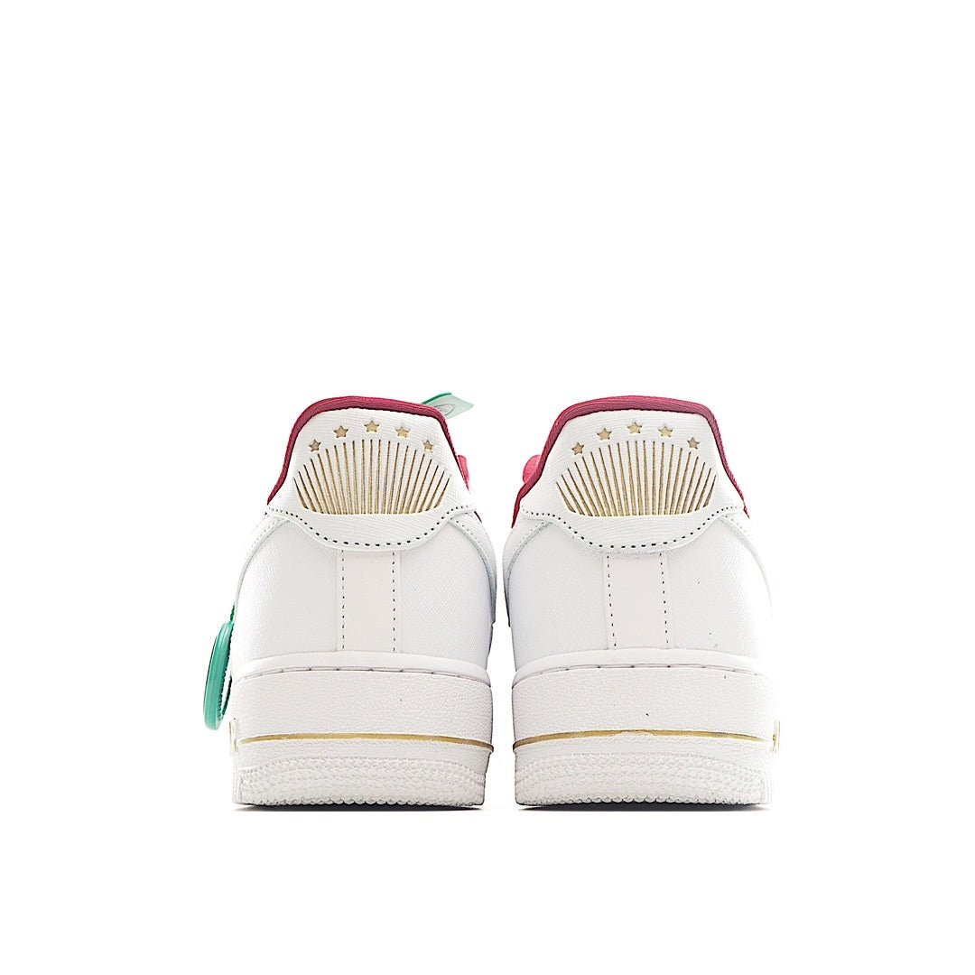 Nike Air Force 1 sneakers in white with rear pink trim and green tag
