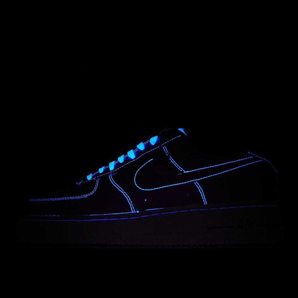 Dark Nike low-top sneaker with glowing blue swoosh and accents