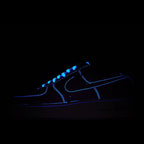 Dark Nike low-top sneaker with glowing blue swoosh and accents