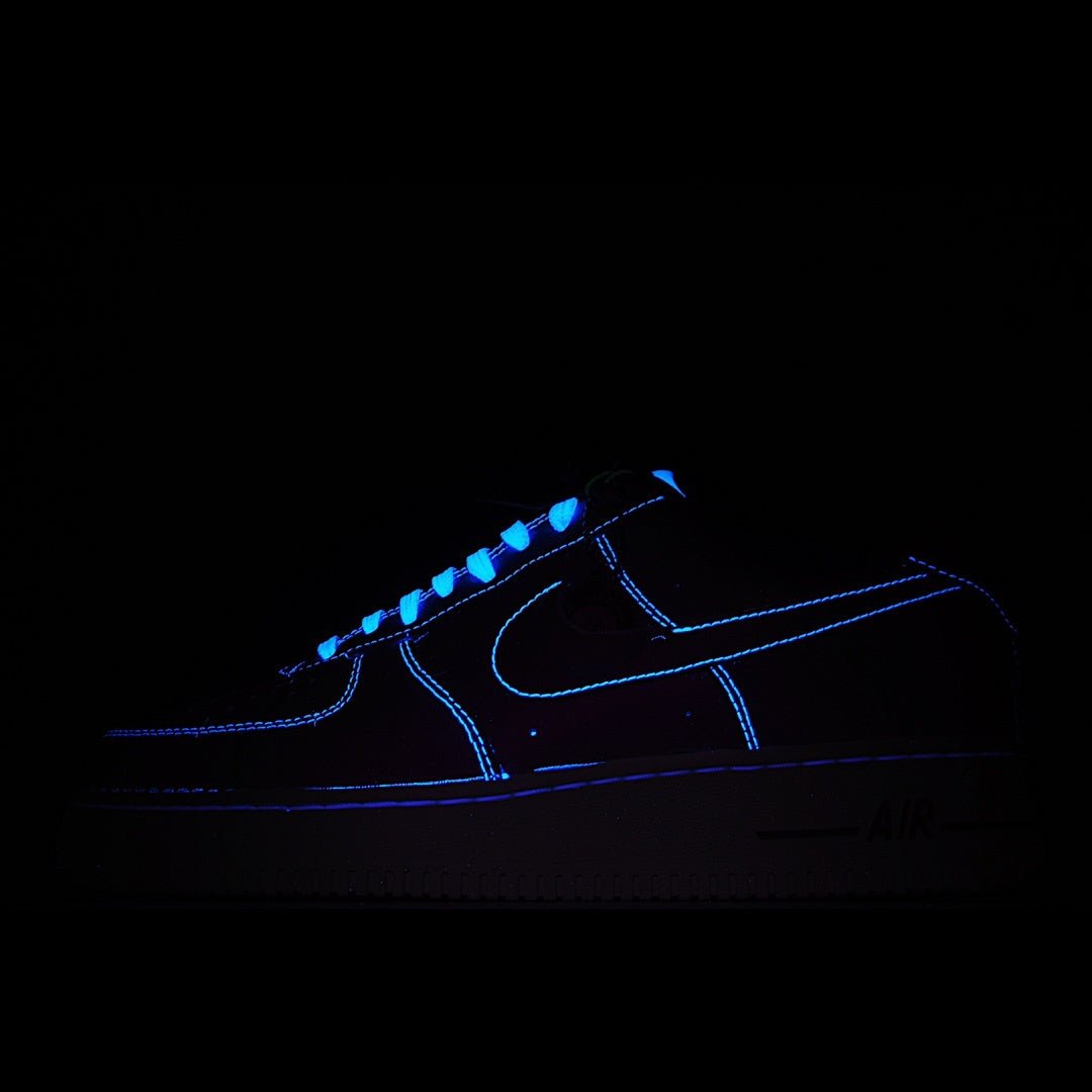 Dark Nike low-top sneaker with glowing blue swoosh and accents