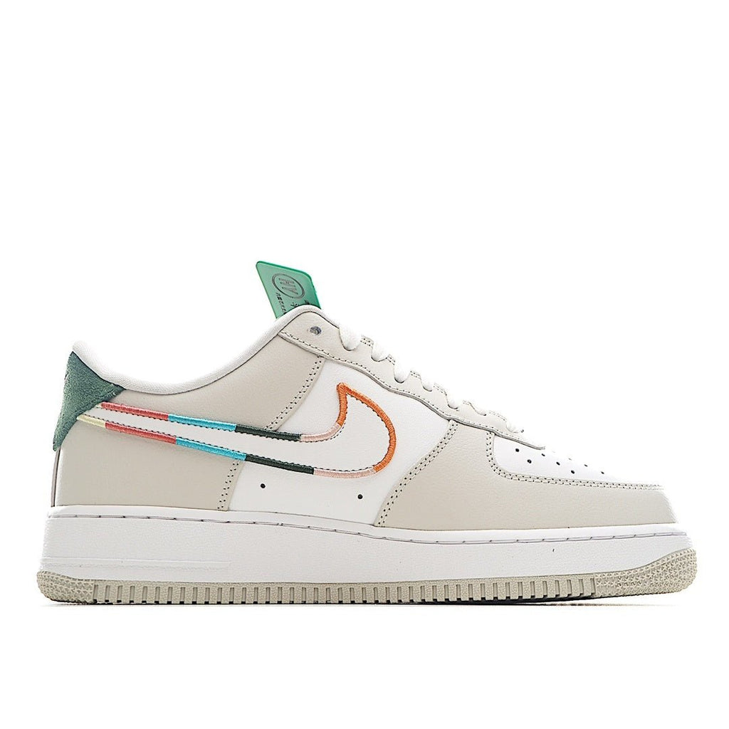 White Air Force 1 sneakers, side view with teal tongue and orange swoosh