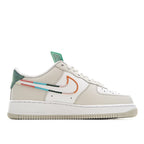 White Air Force 1 sneakers, side view with teal tongue and orange swoosh