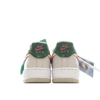 Pair of Air Force 1 sneakers, white uppers with teal ankle panels and orange accents