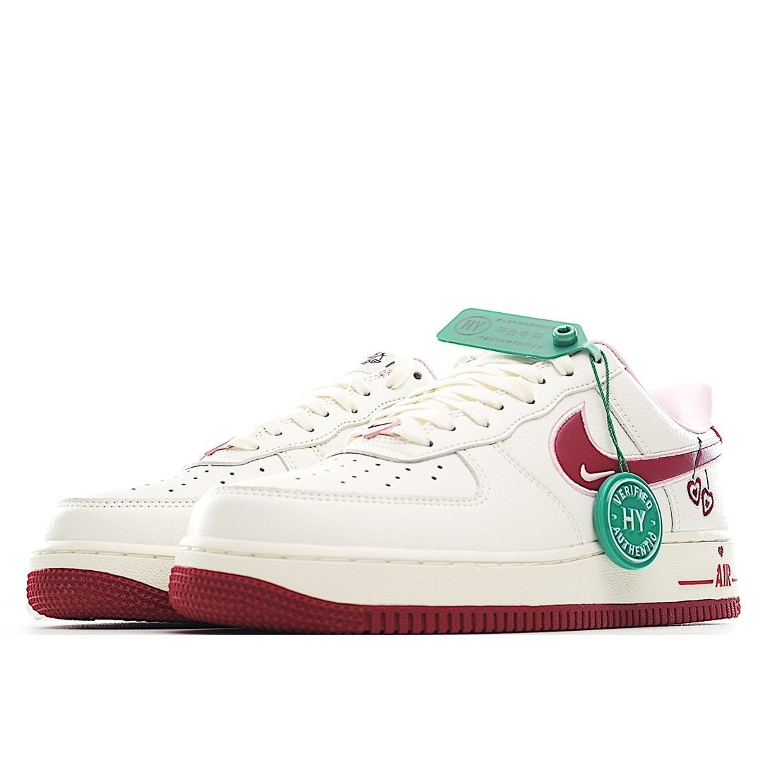 White low-top sneaker with teal collar patch, burgundy swoosh, lace-up