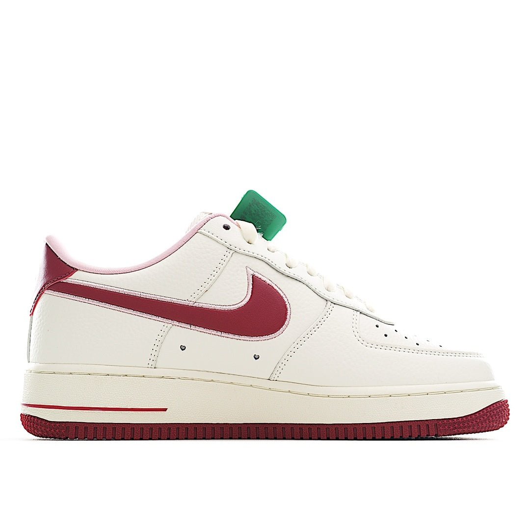 White low-top sneaker with burgundy side stripe and lace-up