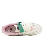 White low-top sneaker with burgundy interior lining and teal hang tag