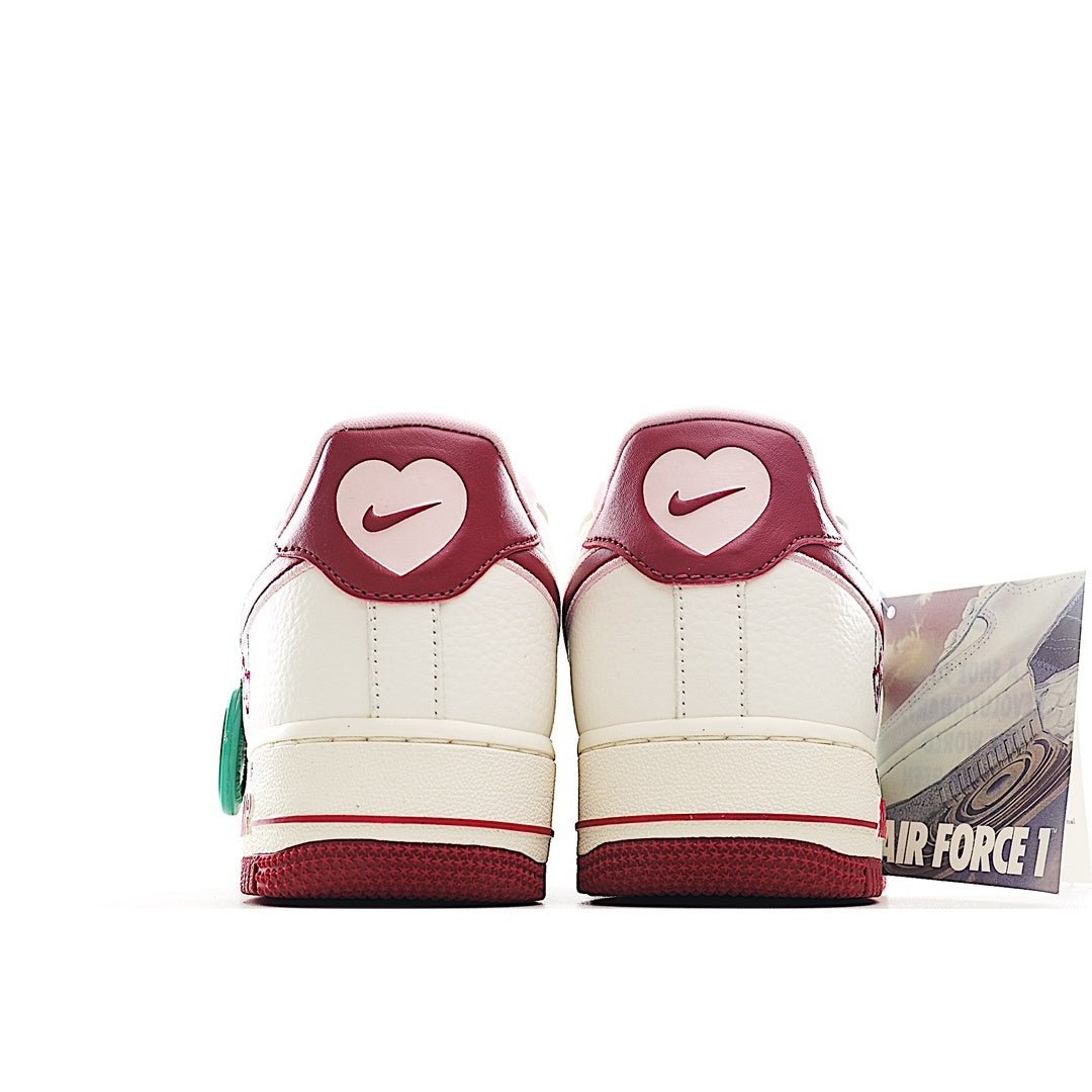 Pair of white low-top sneakers with burgundy heel tabs and teal accents