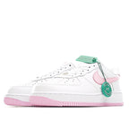 White Nike Air Force 1 sneakers with pink logo, green hang tag, and pink sole