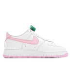White Nike Air Force 1 sneakers with pink swoosh, green lace tag, and pink outsole