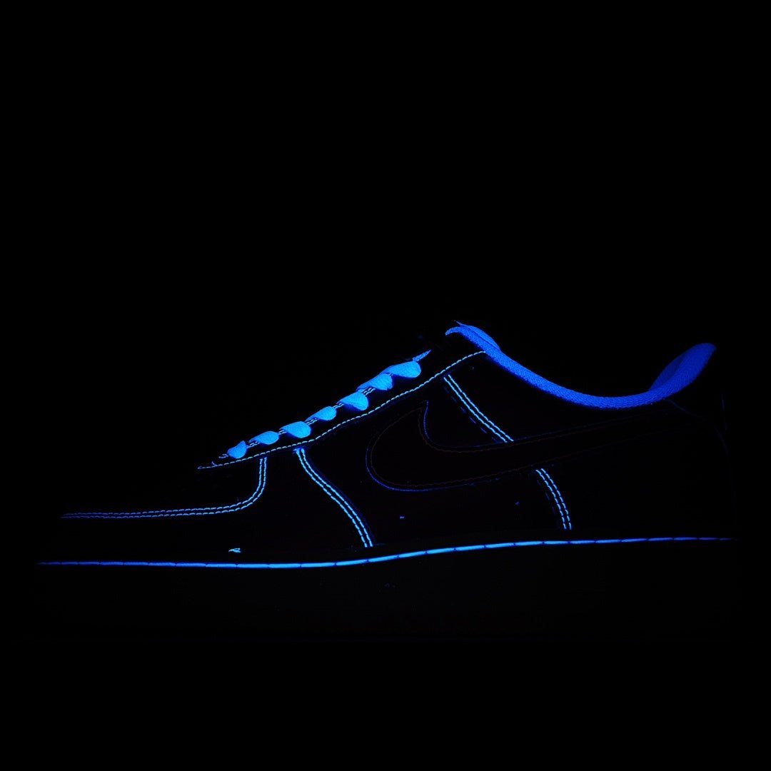 Dark Nike sneakers with blue glowing accents and neon-style outline