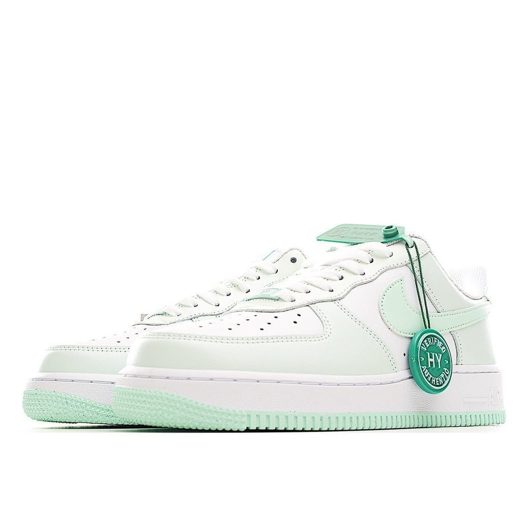 Low-top sneakers, white upper with mint green overlay, laces, and pull tab