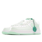 Low-top sneakers, white upper with mint green overlay, laces, and pull tab