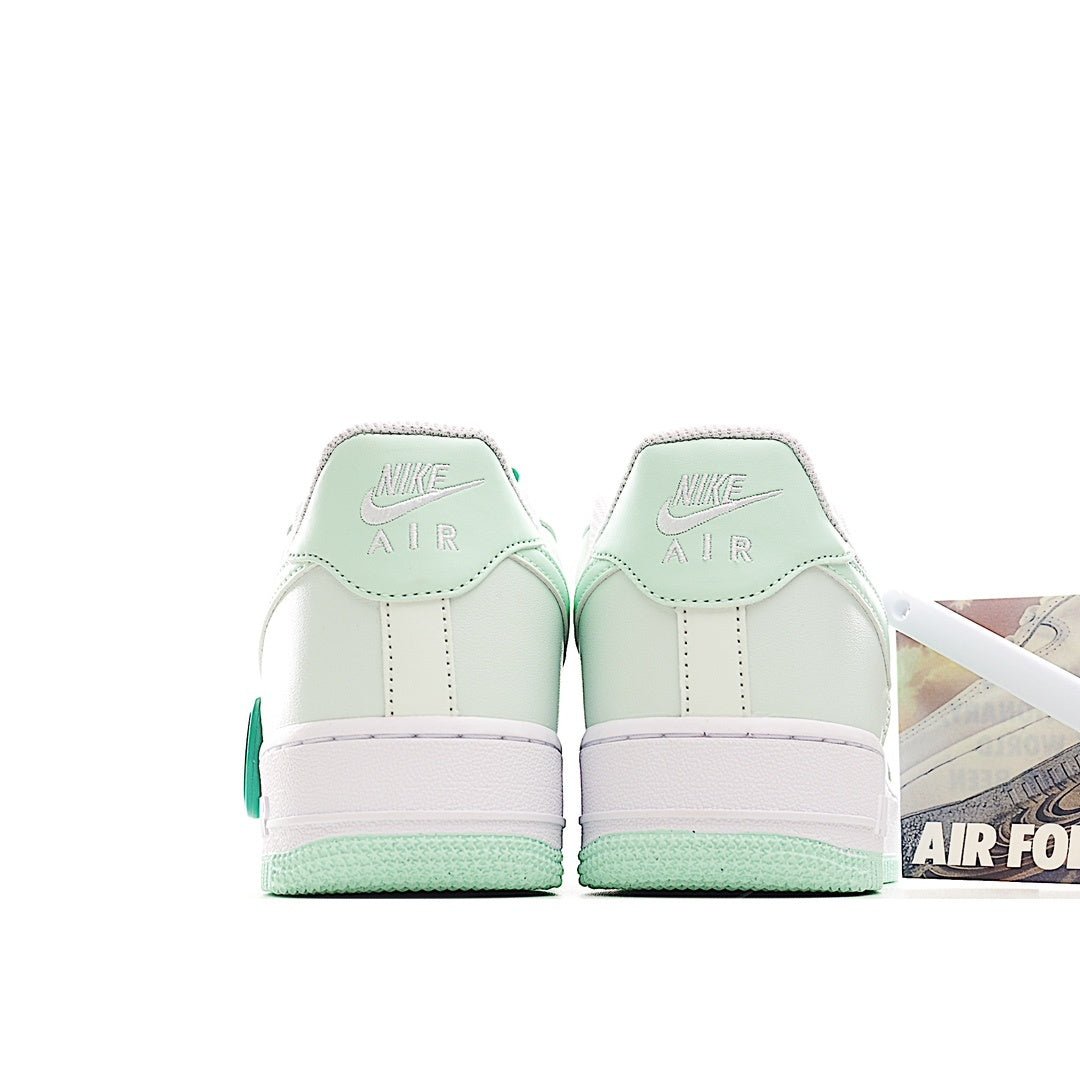 Low-top sneakers heel view, white leather with mint accents and Air branding tabs