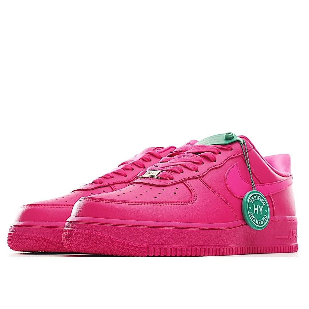 Pink low-top sneakers, side view, green lace loop and circular authenticity badge