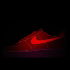Red Nike Air Force 1 low-top sneaker with Swoosh and lace-up detail