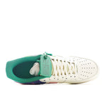 White low-top sneakers with teal interior lining and lace-up front, gum outsole edge