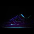 Dark low-top sneakers with blue and green neon accents, lace-up front