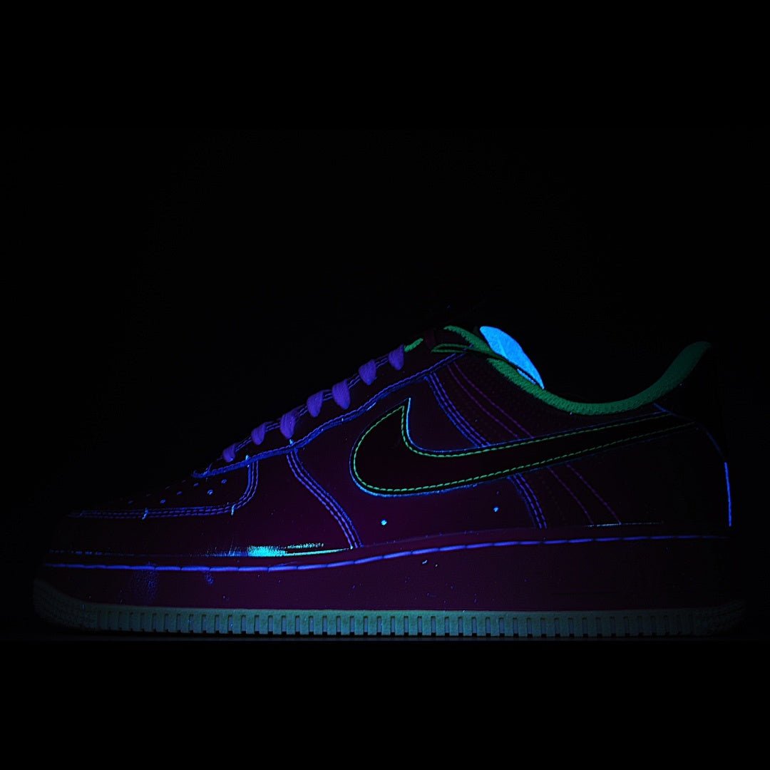 Dark low-top sneakers with blue and green neon accents, lace-up front