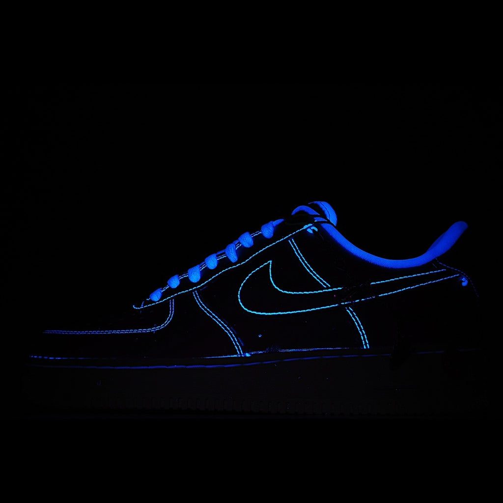 Dark blue low-top sneakers with neon-blue outline, glowing side view