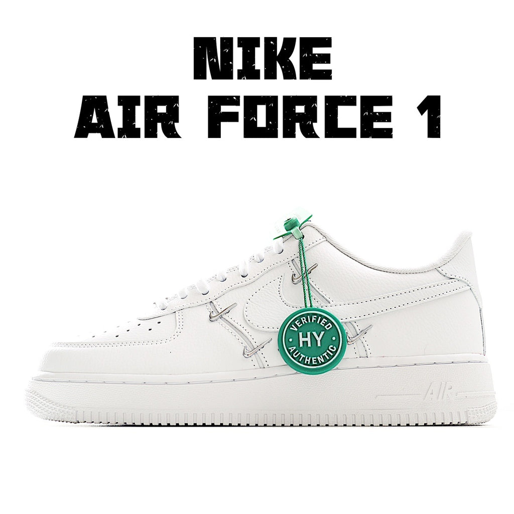 White low-top sneakers with green lace tag and green laces