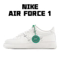 White low-top sneakers with green lace tag and green laces