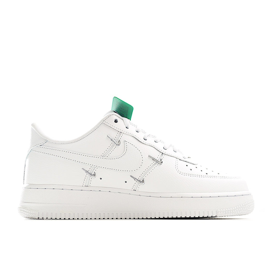 White low-top sneakers, side profile with green-accent lace panel