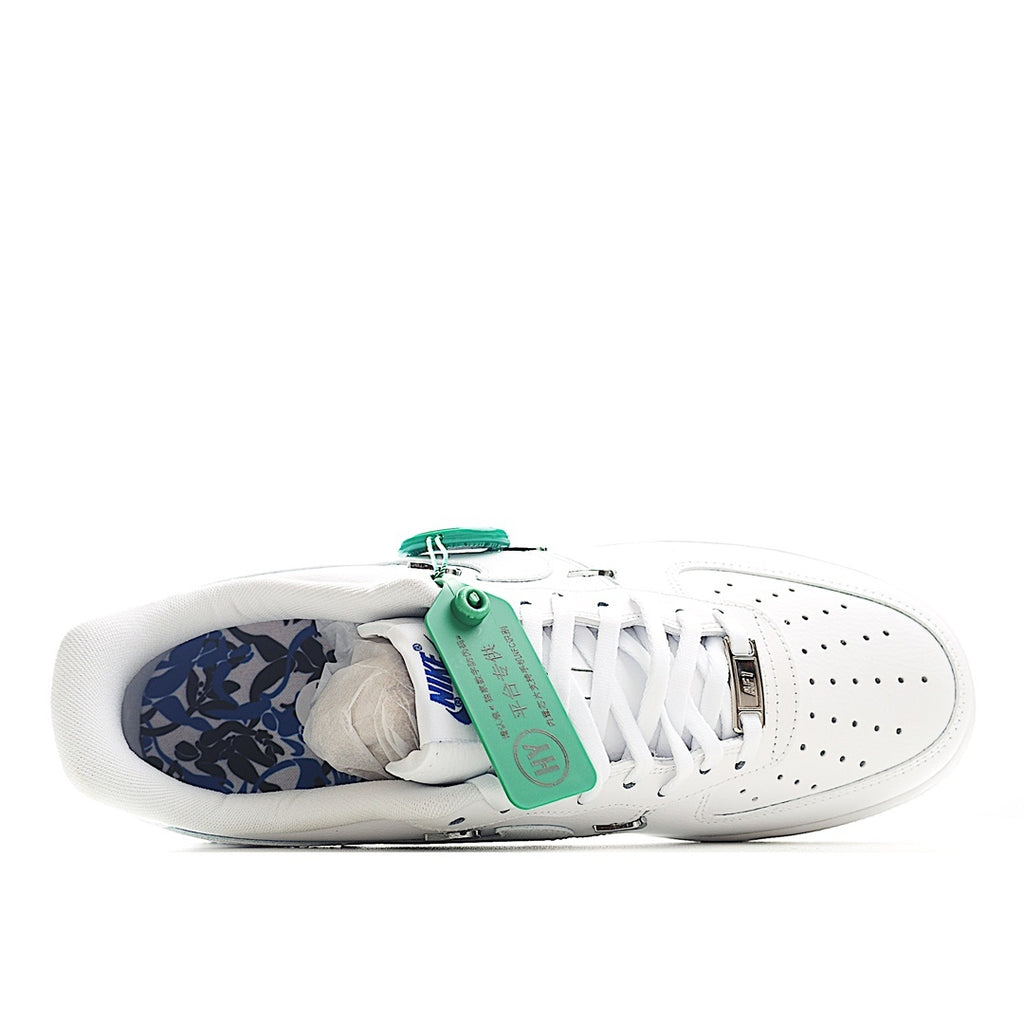 White low-top sneakers with blue patterned inner lining and insole
