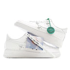 White low-top sneakers with green hang tag and exposed laces