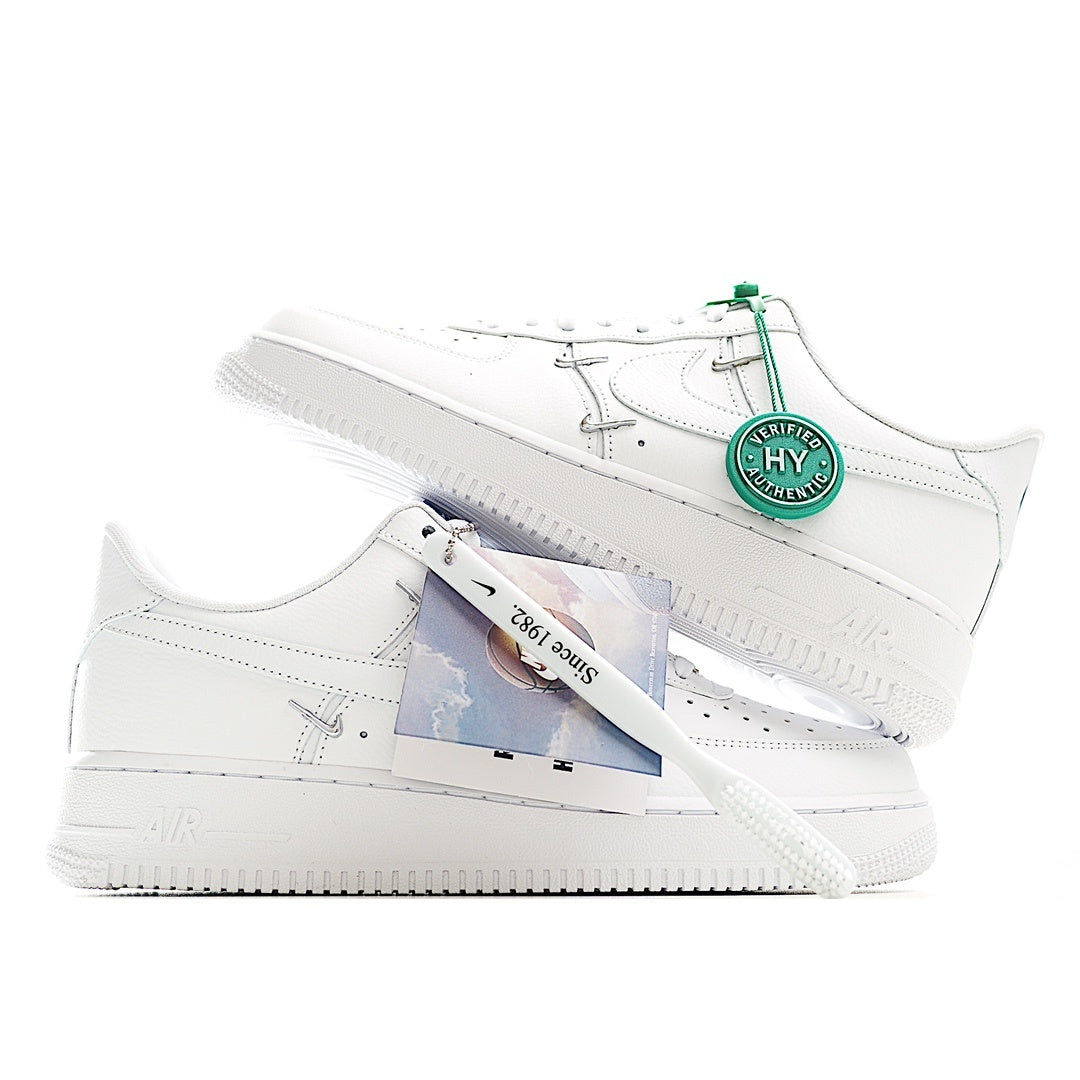 White low-top sneakers with green hang tag and exposed laces