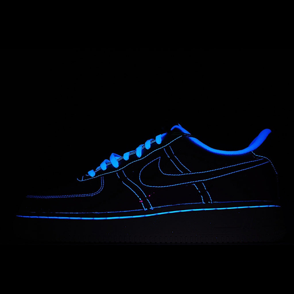 Dark blue low-top sneakers with neon blue outline