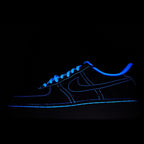 Dark blue low-top sneakers with neon blue outline