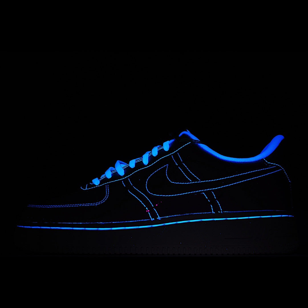 Dark blue low-top sneakers with neon blue outline