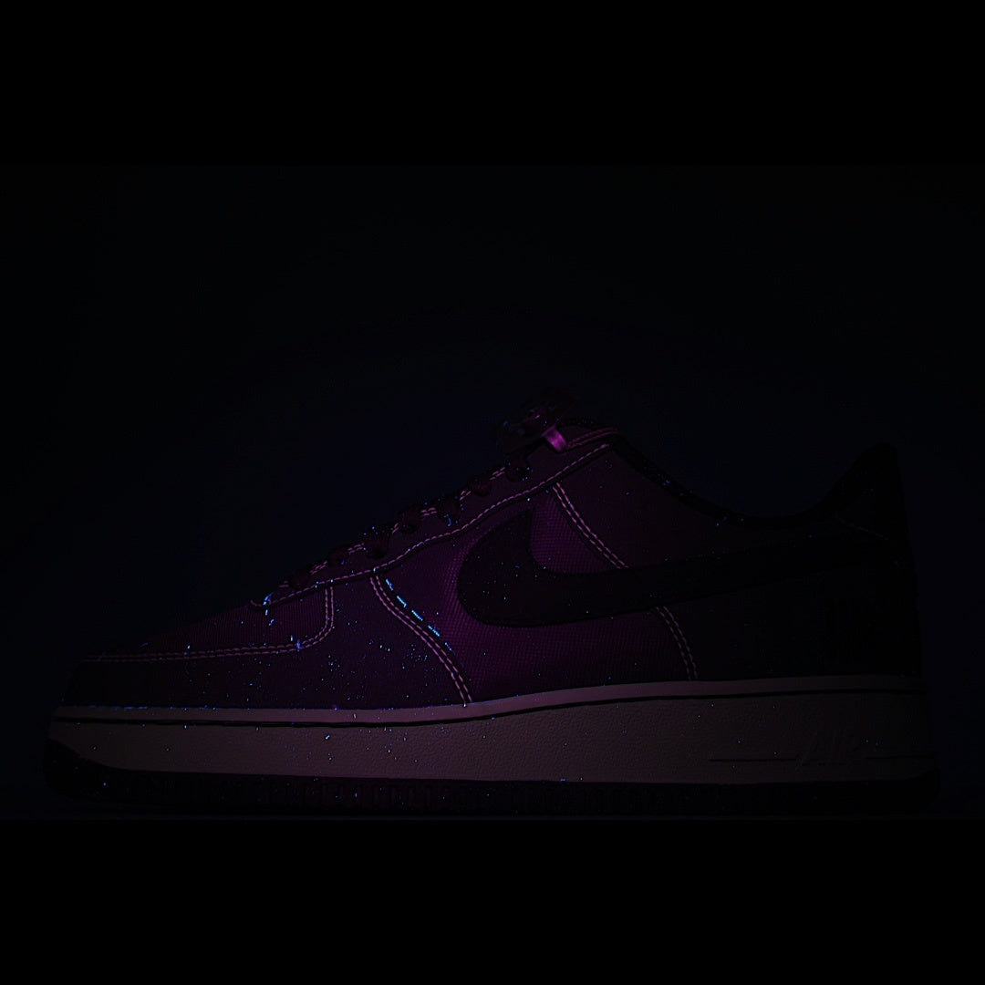 Dark purple-accent low-top lace-up sneaker with swoosh detail