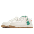 White Nike Air Force 1 sneaker side view with red swoosh, green HY tag, gum sole