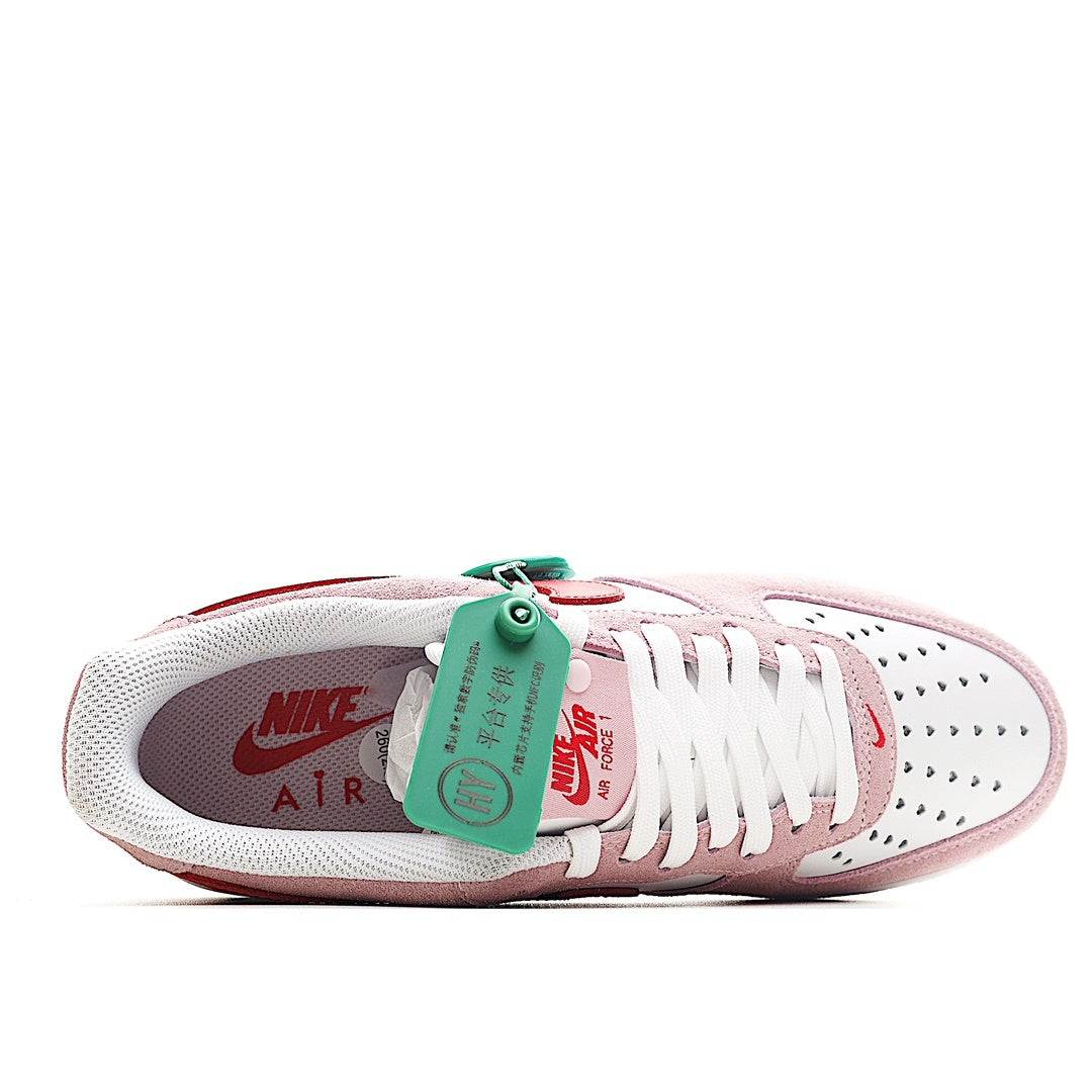 Nike Air Force 1 sneakers, pink and white with green tag and white lace detail
