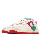 Low-top sneakers with white upper, red side swoosh, and green heel accent
