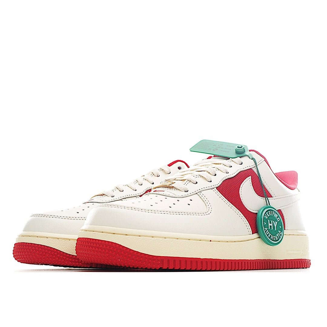 Low-top sneakers with white upper, red side swoosh, and green heel accent