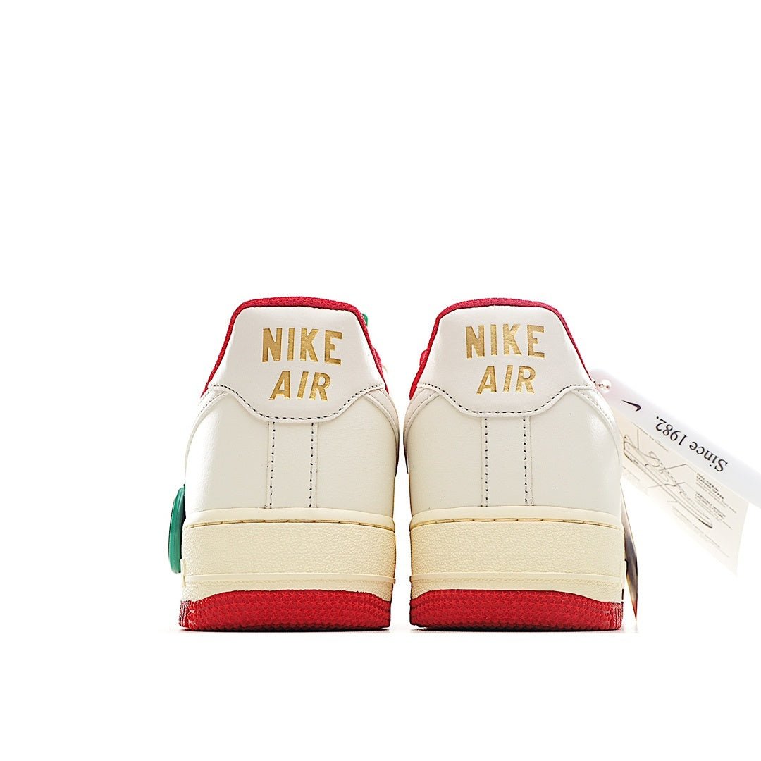 Back view of low-top sneakers with white leather and red heel stripe